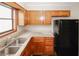 Kitchen boasting granite countertops, stainless steel sink, wood cabinets, and modern appliances at 5461 Park S Pl, Atlanta, GA 30349