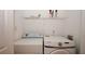 Bright laundry room with washer, dryer and shelving for ample storage at 5461 Park S Pl, Atlanta, GA 30349