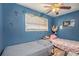 Bedroom featuring two beds, wood-look flooring, and a ceiling fan at 2087 Chestnut Way, Lithia Springs, GA 30122