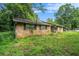 Back view of brick home with a fenced yard and green windows at 2087 Chestnut Way, Lithia Springs, GA 30122