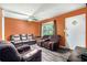 Living room features hardwood floors, orange walls, and natural lighting at 2087 Chestnut Way, Lithia Springs, GA 30122
