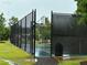 Outdoor community basketball court features chain-link fencing, trees, and a smooth playing surface at 225 Magnolia Tree Ct, Johns Creek, GA 30022