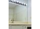Bathroom vanity with chrome fixtures and white tiled wall at 225 Magnolia Tree Ct, Johns Creek, GA 30022