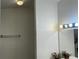 A bright bathroom features white tile and updated lighting fixtures at 225 Magnolia Tree Ct, Johns Creek, GA 30022