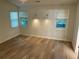 This bedroom features hardwood floors, two windows and sconce lighting at 225 Magnolia Tree Ct, Johns Creek, GA 30022