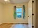 Bedroom with hardwood floors, window and closet at 225 Magnolia Tree Ct, Johns Creek, GA 30022