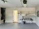 Spacious garage with ample workspace and shelving at 225 Magnolia Tree Ct, Johns Creek, GA 30022
