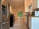 Stainless steel refrigerator and open view into a large sunny backyard at 225 Magnolia Tree Ct, Johns Creek, GA 30022