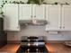 A modern kitchen boasts stainless steel appliances and bright white cabinets at 225 Magnolia Tree Ct, Johns Creek, GA 30022