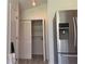 This kitchen features a stainless steel refrigerator and a pantry with bi-fold doors at 225 Magnolia Tree Ct, Johns Creek, GA 30022