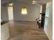A spacious living room features a stone fireplace and modern lighting at 225 Magnolia Tree Ct, Johns Creek, GA 30022