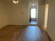 An airy living room features hardwood floors and a bright entryway door at 225 Magnolia Tree Ct, Johns Creek, GA 30022