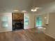 A spacious living room features a stone fireplace and sliding glass doors at 225 Magnolia Tree Ct, Johns Creek, GA 30022