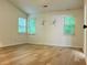 Spacious main bedroom with hardwood floors and multiple windows at 225 Magnolia Tree Ct, Johns Creek, GA 30022