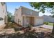 Exterior view of home with a garage, covered back porch and backyard with a flowerbed at 3223 Tallon Sw Ln, Atlanta, GA 30311