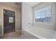 Bright bathroom with a soaking tub and a view into the bedroom at 3223 Tallon Sw Ln, Atlanta, GA 30311