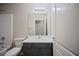 Bathroom with shower, toilet, and vanity with a large mirror and modern lighting at 3223 Tallon Sw Ln, Atlanta, GA 30311
