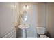 Simple bathroom with toilet, sink and mirror, featuring neutral color palette at 3223 Tallon Sw Ln, Atlanta, GA 30311