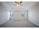 Spacious bedroom featuring neutral paint, two windows, and a ceiling fan at 3223 Tallon Sw Ln, Atlanta, GA 30311
