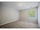 Carpeted bedroom with neutral walls, natural light from the window, and overhead lighting at 3223 Tallon Sw Ln, Atlanta, GA 30311