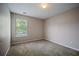 Carpeted bedroom with neutral walls, natural light from the window, and overhead lighting at 3223 Tallon Sw Ln, Atlanta, GA 30311