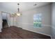Dining area with wood floors, modern light fixture, and access to upper level staircase at 3223 Tallon Sw Ln, Atlanta, GA 30311