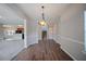 Dining room with wood flooring, stylish light fixture, and access to kitchen and living areas at 3223 Tallon Sw Ln, Atlanta, GA 30311