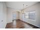 Bright dining room featuring wood-look floors, natural light and views of the fenced back yard at 3223 Tallon Sw Ln, Atlanta, GA 30311