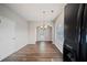 Cozy dining area with wood floors, modern lighting, and black appliances nearby at 3223 Tallon Sw Ln, Atlanta, GA 30311