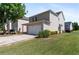 Exterior of home with green grass, lush landscaping and an attached garage with driveway at 3223 Tallon Sw Ln, Atlanta, GA 30311