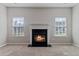 Inviting living room fireplace is flanked by windows and features neutral decor at 3223 Tallon Sw Ln, Atlanta, GA 30311