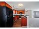 Well-equipped kitchen featuring cherry cabinets, black appliances, and convenient breakfast bar at 3223 Tallon Sw Ln, Atlanta, GA 30311