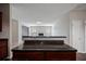 Open-concept kitchen with granite counters looking to carpeted living room with fireplace at 3223 Tallon Sw Ln, Atlanta, GA 30311