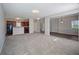 Inviting living space with carpeted floors and an open layout connecting to kitchen and dining area at 3223 Tallon Sw Ln, Atlanta, GA 30311