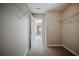 Walk-in closet featuring open shelving, carpet flooring and an open door at 3223 Tallon Sw Ln, Atlanta, GA 30311