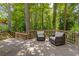 Relax on the wooden back deck with chairs and enjoy the trees and nature surrounding this property at 3362 Northbrook Dr, Atlanta, GA 30340