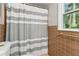 Bathroom showcasing a shower with a striped curtain and warm-toned tile at 3362 Northbrook Dr, Atlanta, GA 30340
