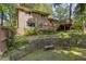 Exterior side view featuring brick, large windows, and an elevated deck with stairs in a beautiful location at 3362 Northbrook Dr, Atlanta, GA 30340