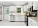 Bright kitchen featuring white cabinets, granite countertops, and stainless steel appliances at 3362 Northbrook Dr, Atlanta, GA 30340