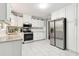 Well-lit kitchen with white cabinets, stainless steel appliances, and modern fixtures at 3362 Northbrook Dr, Atlanta, GA 30340