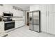 Well-lit kitchen with white cabinets, stainless steel appliances, and modern fixtures at 3362 Northbrook Dr, Atlanta, GA 30340