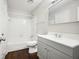 Bathroom with a single sink vanity, tub, and shower featuring modern fixtures at 5555 Mountain Springs Cir, Stone Mountain, GA 30088
