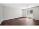 Bright bedroom featuring a large window, hardwood floors, and neutral paint at 5555 Mountain Springs Cir, Stone Mountain, GA 30088