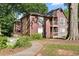 Charming home exterior featuring wood siding, walkways, and mature trees at 5555 Mountain Springs Cir, Stone Mountain, GA 30088