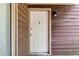 Close-up of a white front door with a decorative knocker and house number, exuding curb appeal at 5555 Mountain Springs Cir, Stone Mountain, GA 30088