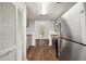 Efficient kitchen with stainless steel refrigerator and stove, gray cabinets, and hardwood floors at 5555 Mountain Springs Cir, Stone Mountain, GA 30088