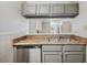 Galley kitchen featuring gray cabinets, stainless steel appliances, and plenty of countertop space at 5555 Mountain Springs Cir, Stone Mountain, GA 30088