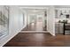 Modern kitchen with hardwood floors, stainless steel appliances, and view into the living room at 5555 Mountain Springs Cir, Stone Mountain, GA 30088