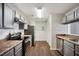 A kitchen with wood flooring, gray cabinets, stainless steel appliances, and white subway tile at 5555 Mountain Springs Cir, Stone Mountain, GA 30088