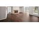 Spacious living room featuring a brick fireplace, hardwood floors, and large windows with natural light at 5555 Mountain Springs Cir, Stone Mountain, GA 30088